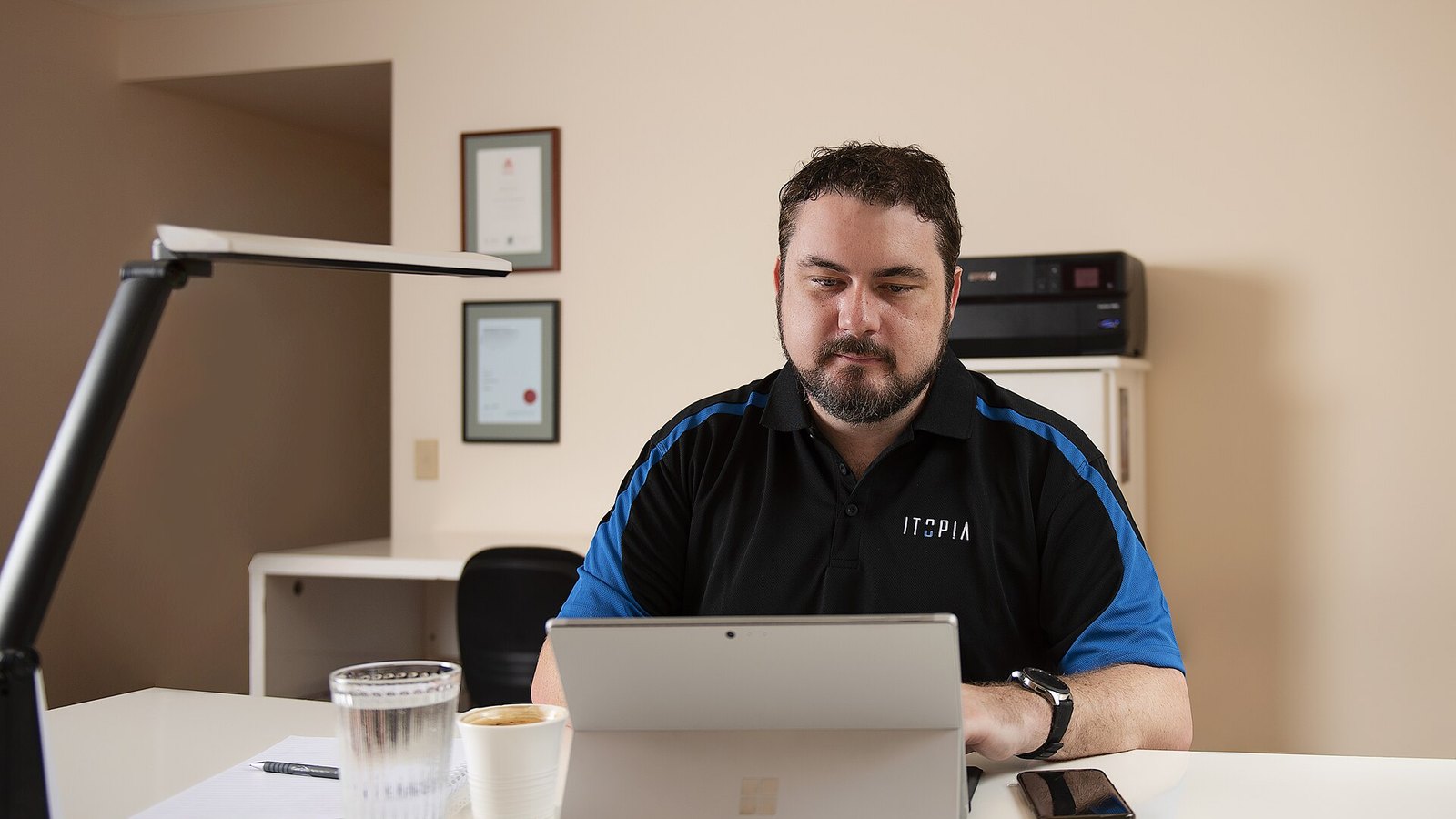 An IT support office with staff at their desks